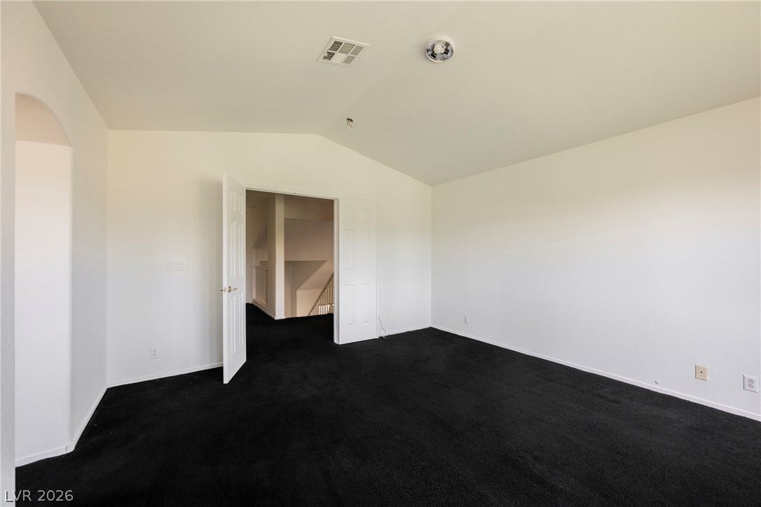 1608 Saddle Rock Circle, Las Vegas, NV 89117 Vaulted ceilings elevate this versatile upper-level room featuring deep-toned carpeting.