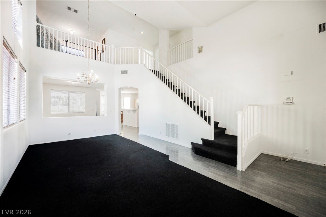 1608 Saddle Rock Circle, Las Vegas, NV 89117 A soaring vaulted ceiling and a prominent open staircase anchor this grand multi-level interior.