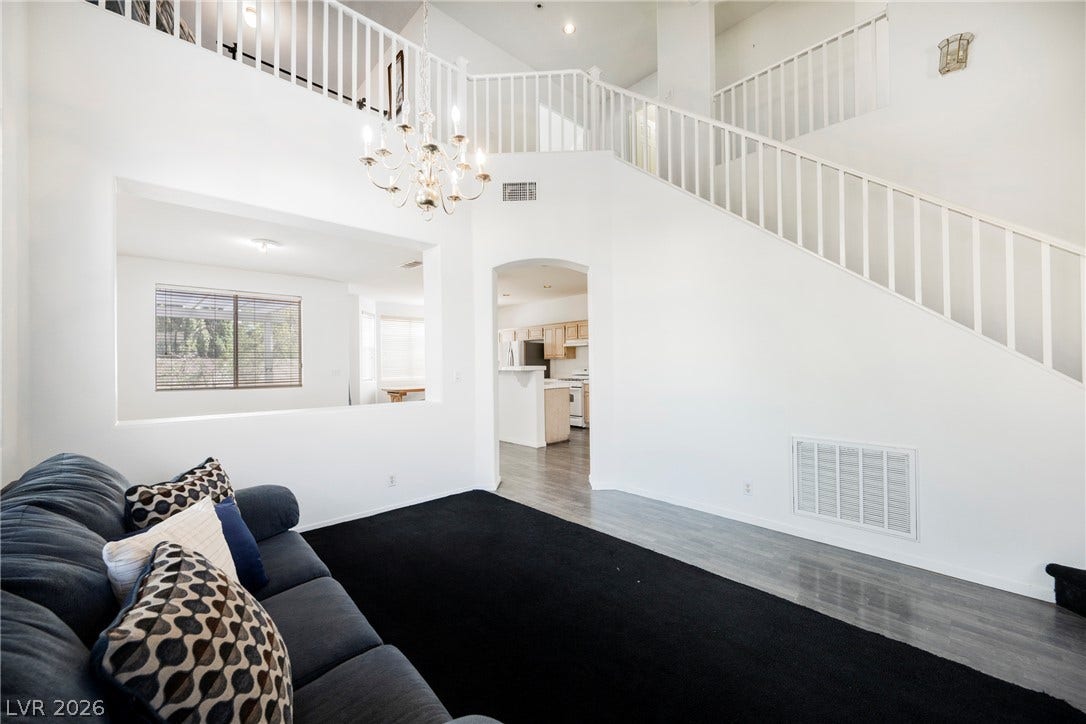 1608 Saddle Rock Circle, Las Vegas, NV 89117 Dramatic vaulted ceilings and a classic chandelier elevate this light-filled dual-level living space.