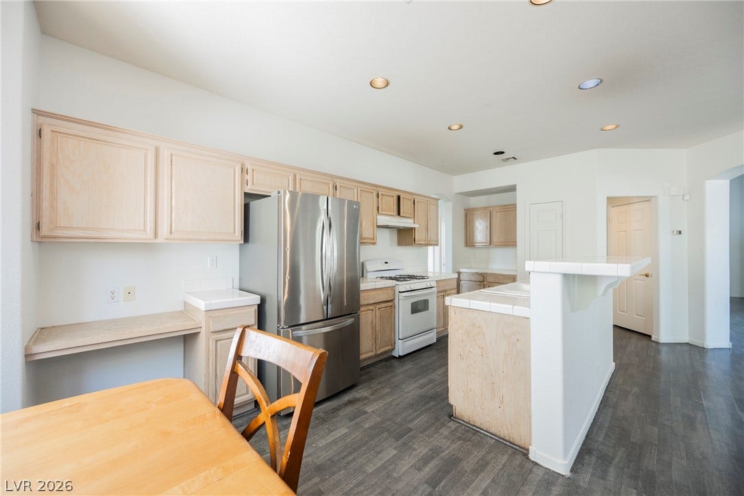 1608 Saddle Rock Circle, Las Vegas, NV 89117 Gleaming wood-look floors pair perfectly with classic tile countertops and clean cabinetry details.