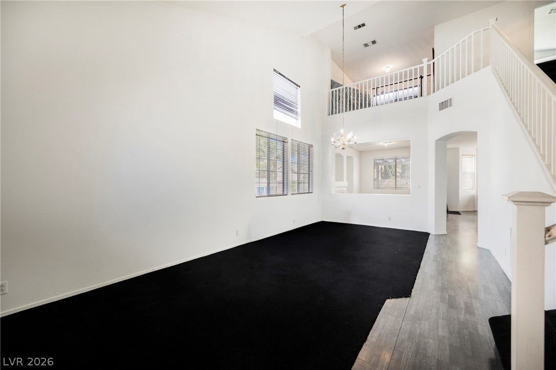 1608 Saddle Rock Circle, Las Vegas, NV 89117 Towering ceilings and an open-concept loft overlook this versatile living area with dual-level windows.