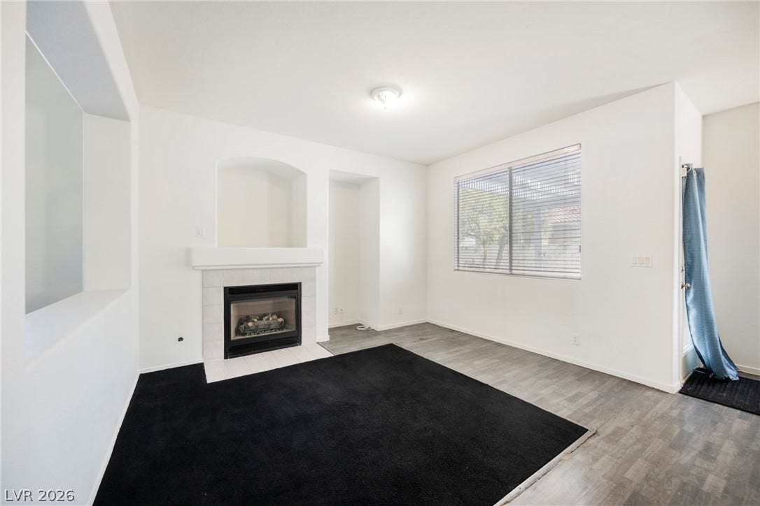 1608 Saddle Rock Circle, Las Vegas, NV 89117 An inviting fireplace serves as the focal point of this versatile living space.
