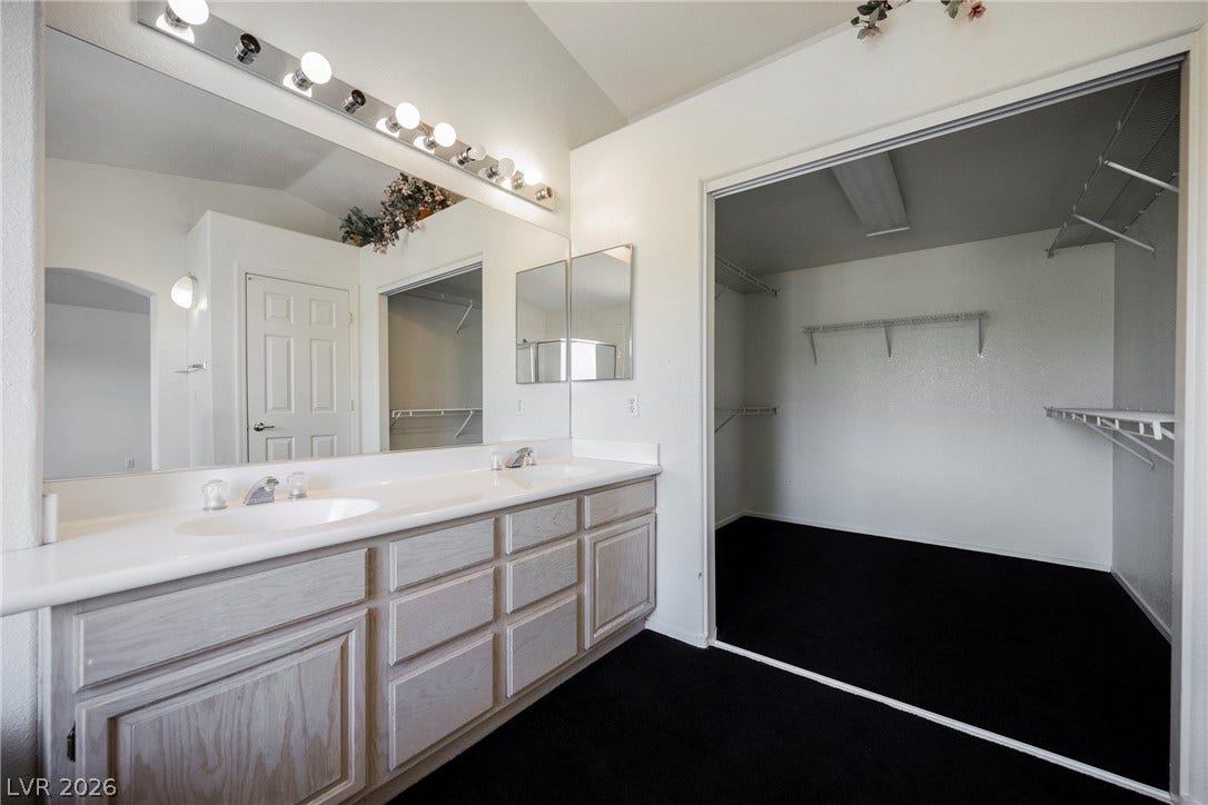 1608 Saddle Rock Circle, Las Vegas, NV 89117 An expansive vanity area connects seamlessly to a spacious walk-in closet with built-in shelving.