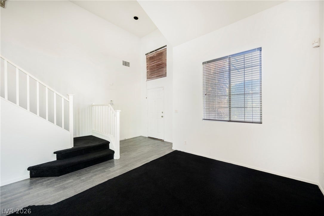 1608 Saddle Rock Circle, Las Vegas, NV 89117 Vaulted ceilings and wood-look flooring enhance the open entryway and carpeted living space.