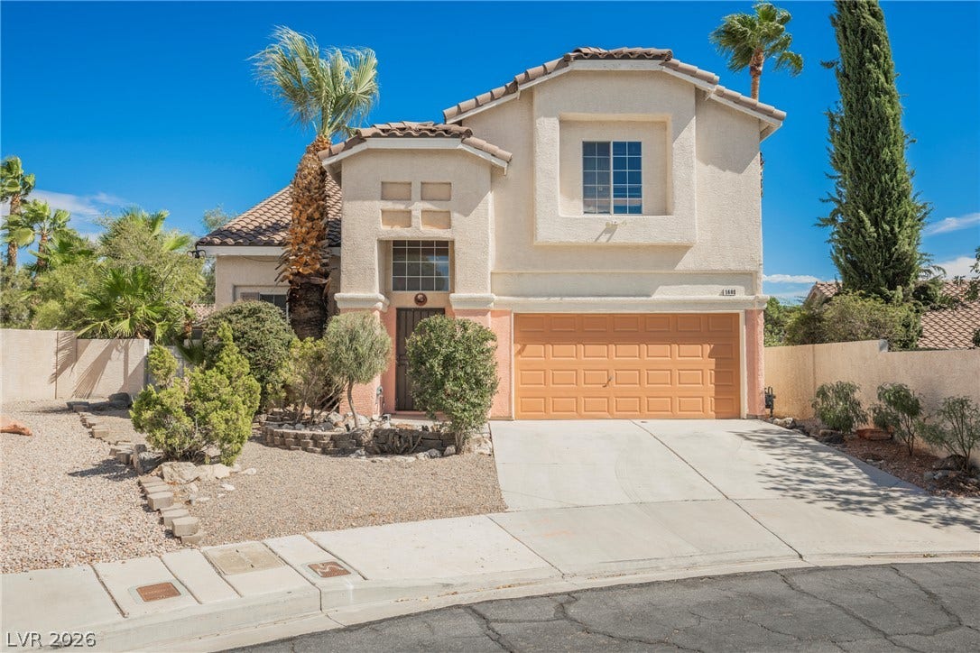 1608 Saddle Rock Circle, Las Vegas, NV 89117 Stucco walls and a tiled roof define the exterior of this two-story home.