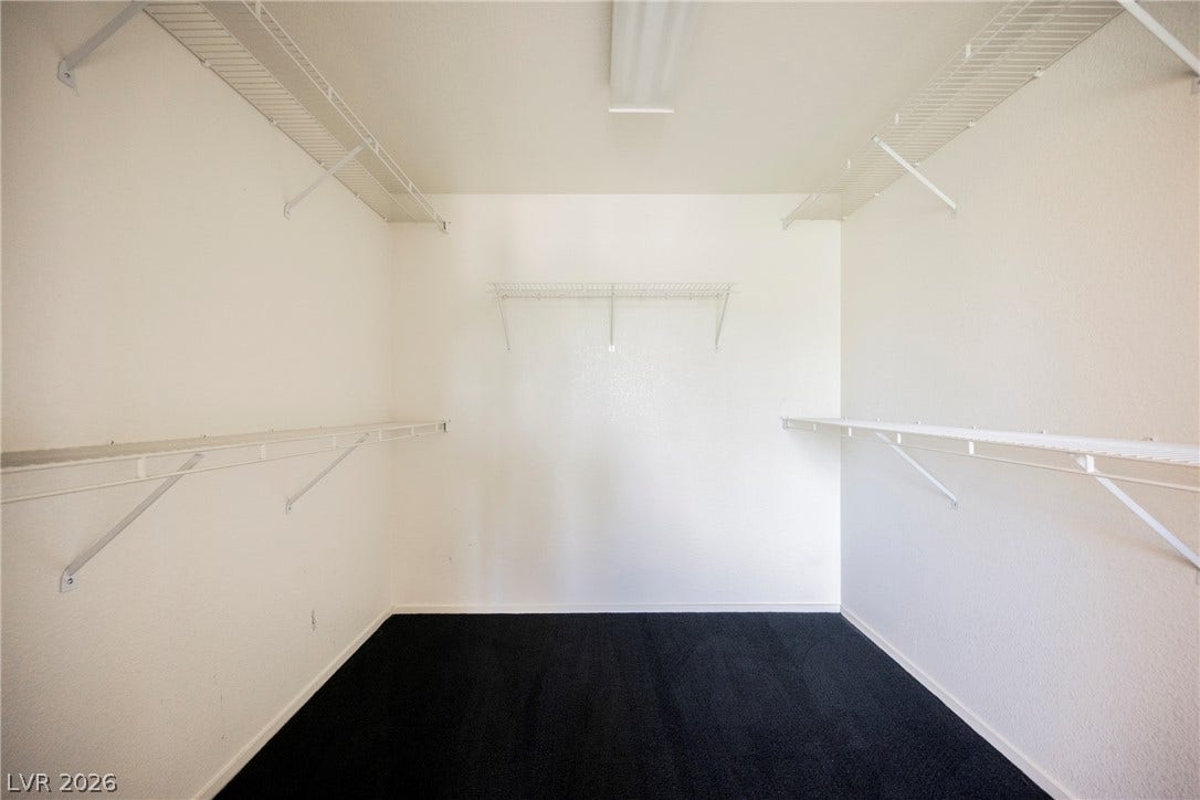 1608 Saddle Rock Circle, Las Vegas, NV 89117 An organized walk-in closet boasts wire shelving and dark carpeting.