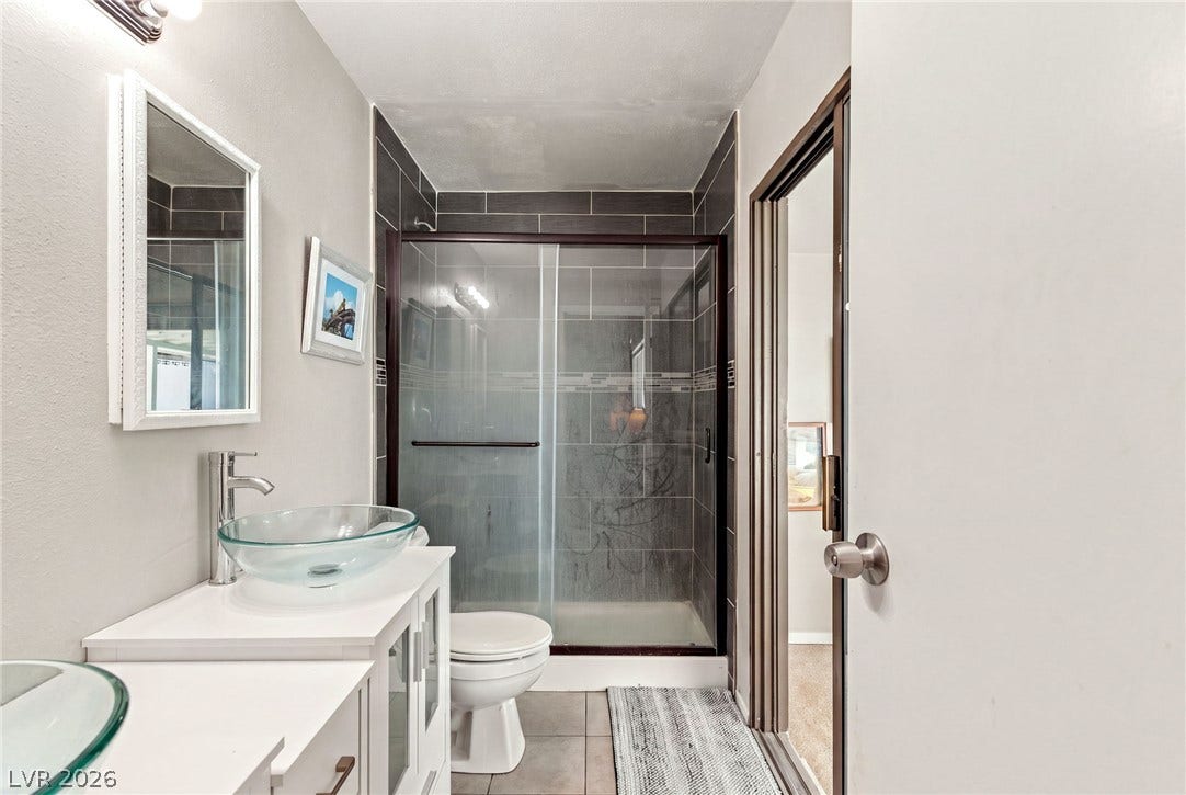 Clean lines and a walk-in tile shower define this modern bathroom space.