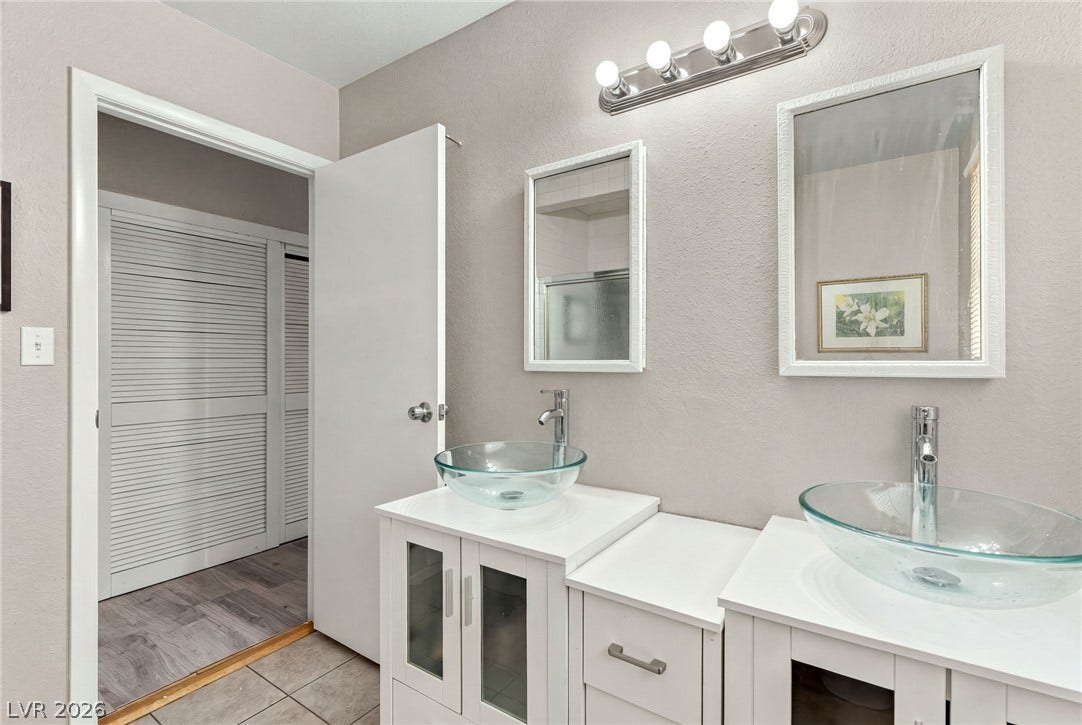 Double vanity sinks and clean neutral finishes define this updated space.