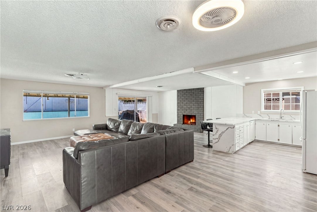 An open floor plan seamlessly connects the kitchen to the bright living areas.