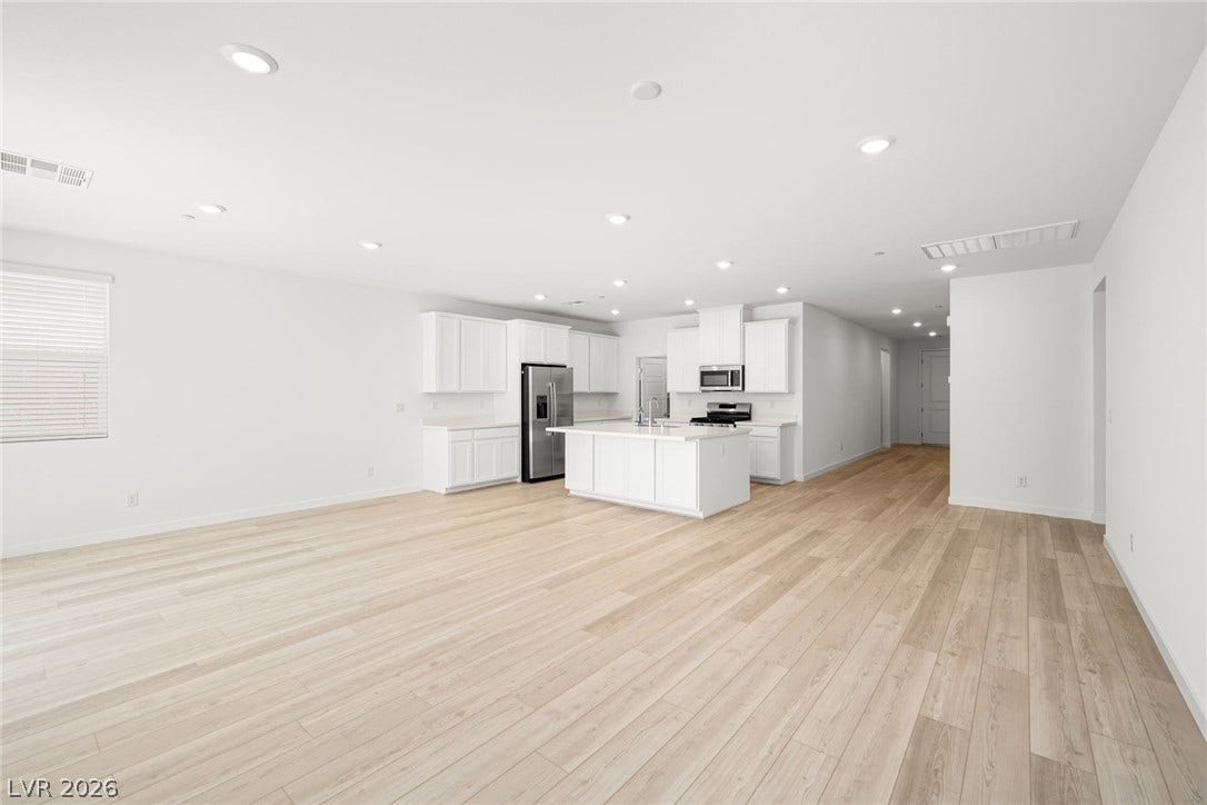 1429 Bianca Falls Drive, Henderson, NV 89011 An open-concept living area flows seamlessly into the kitchen with light wood-style flooring throughout.