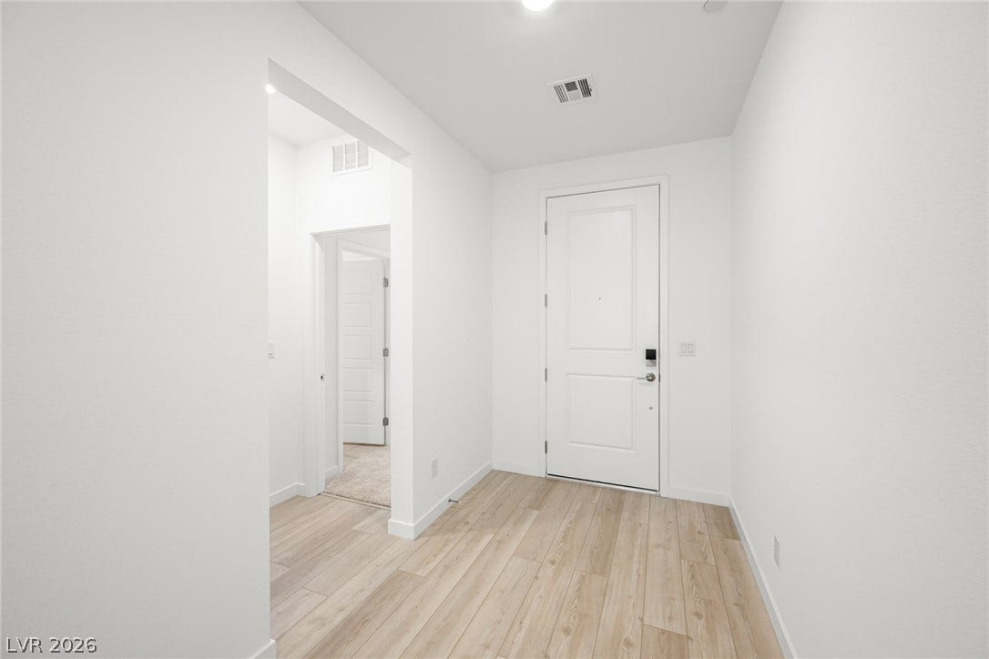 1429 Bianca Falls Drive, Henderson, NV 89011 Gleaming wood-look floors welcome guests inside this pristine foyer space.