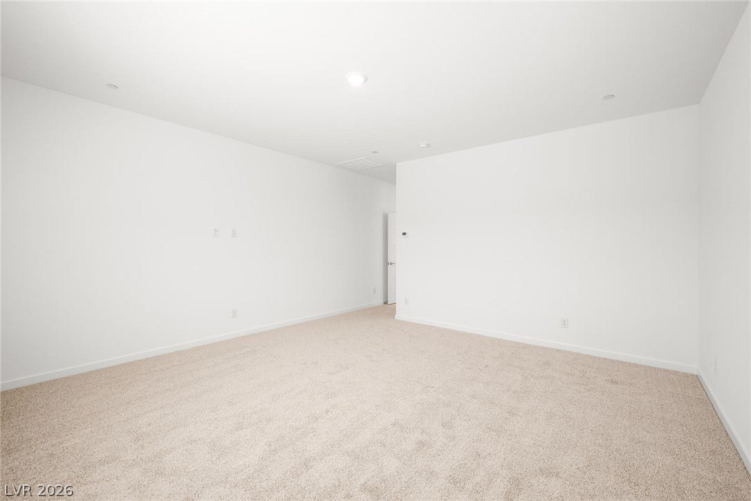 1429 Bianca Falls Drive, Henderson, NV 89011 Crisp white walls and plush carpeting define this versatile, neutral interior space.