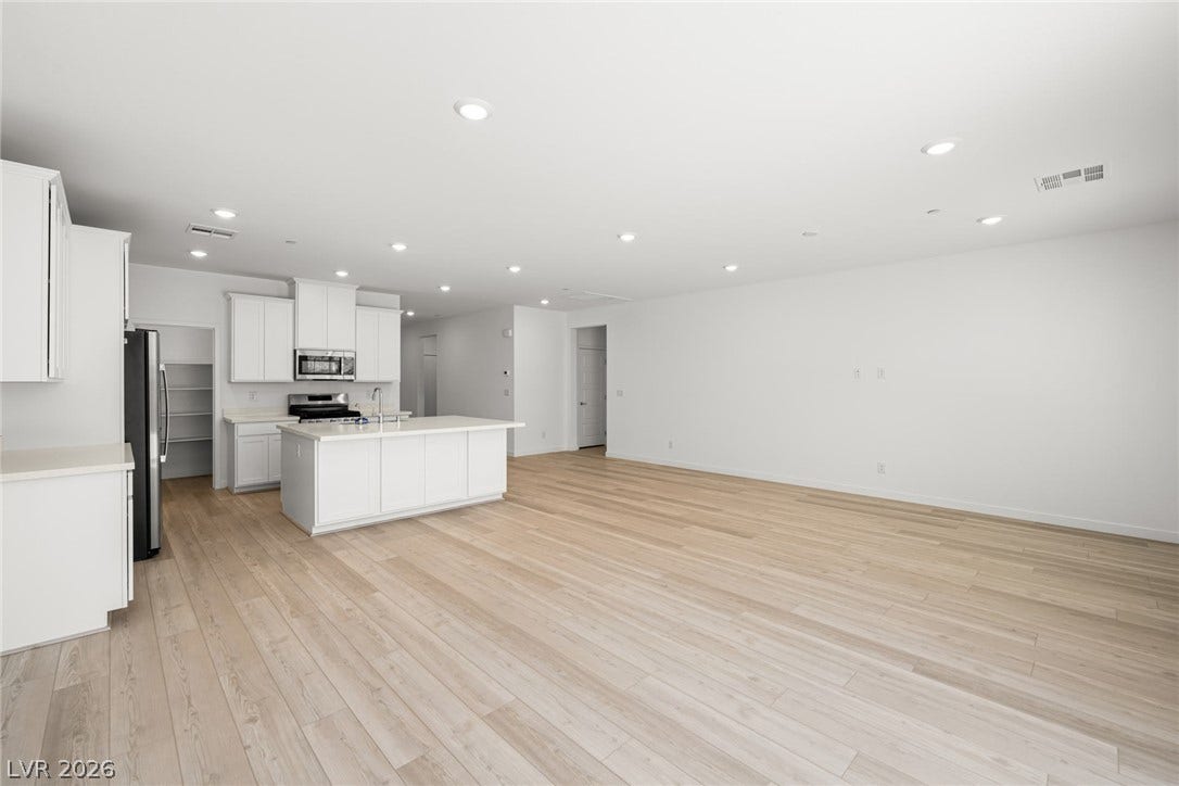 1429 Bianca Falls Drive, Henderson, NV 89011 Smooth wood flooring flows throughout a spacious open kitchen and living area with recessed lighting.