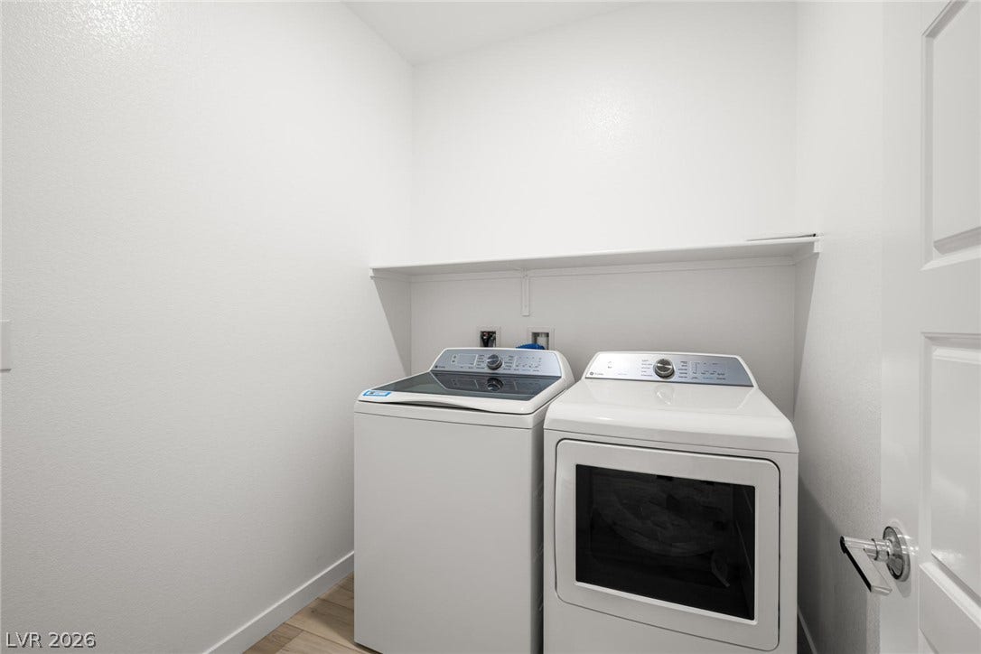 1429 Bianca Falls Drive, Henderson, NV 89011 Functional workspace features a built-in shelf above the laundry units and durable wood-look flooring.
