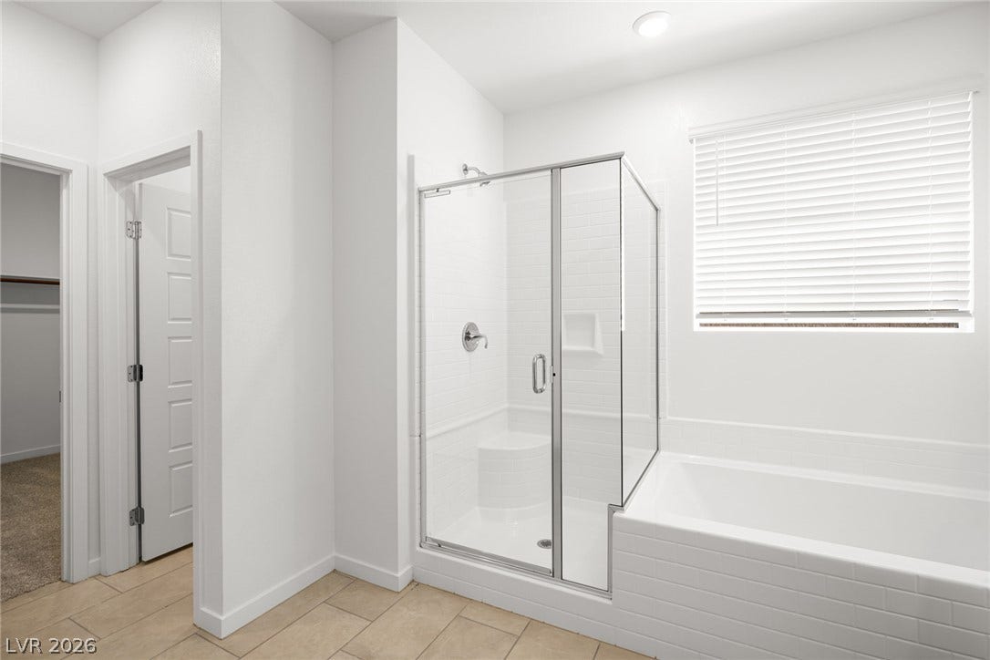 1429 Bianca Falls Drive, Henderson, NV 89011 A glass-enclosed shower and adjacent soaking tub offer clean architectural lines under recessed lighting.