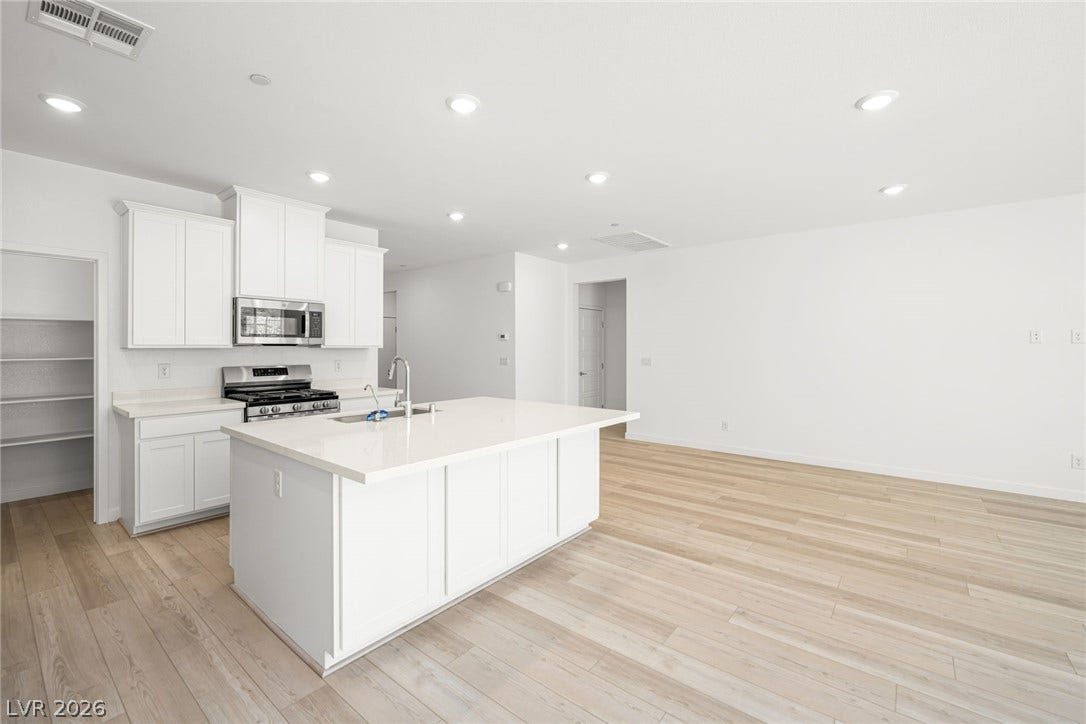 1429 Bianca Falls Drive, Henderson, NV 89011 Clean lines and light flooring define this expansive open-concept kitchen and living area.