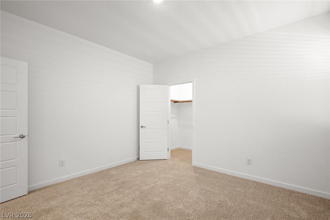 1429 Bianca Falls Drive, Henderson, NV 89011 Soft carpeting underfoot defines this comfortable bedroom complete with a walk-in closet.