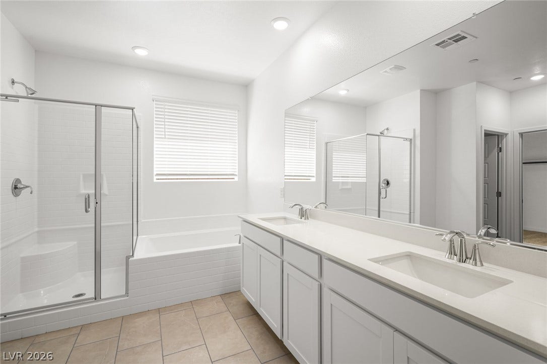 1429 Bianca Falls Drive, Henderson, NV 89011 Clean lines and a spacious dual vanity define this modern primary bathroom design.