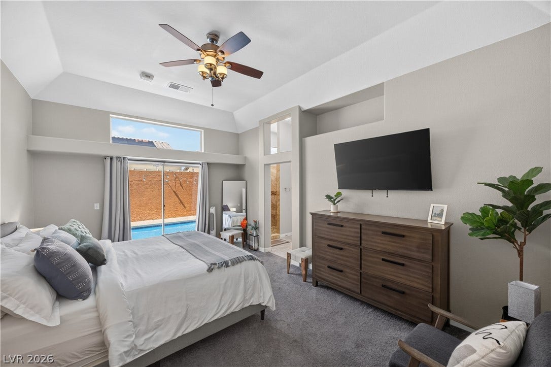 530 Rancho Del Mar Way, North Las Vegas, NV 89031 High ceilings and a sliding glass door opening to the pool define this master bedroom.