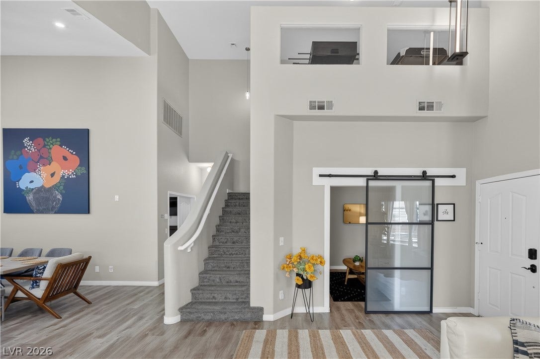 530 Rancho Del Mar Way, North Las Vegas, NV 89031 High ceilings and a modern sliding door define this inviting open entryway.