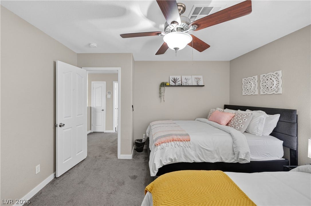 530 Rancho Del Mar Way, North Las Vegas, NV 89031 Plush carpeting anchors this comfortable sleeping space offering seamless transitions to adjacent rooms.
