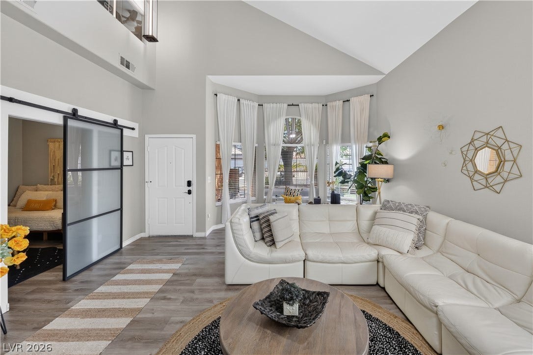 530 Rancho Del Mar Way, North Las Vegas, NV 89031 Dramatic vaulted ceilings and wide-plank wood flooring elevate this welcoming living space.