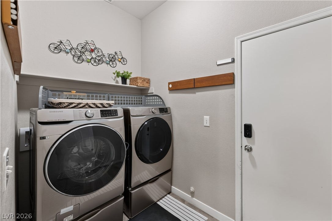 530 Rancho Del Mar Way, North Las Vegas, NV 89031 A dedicated laundry space incorporates convenient built-in shelving alongside a secure utility entrance.