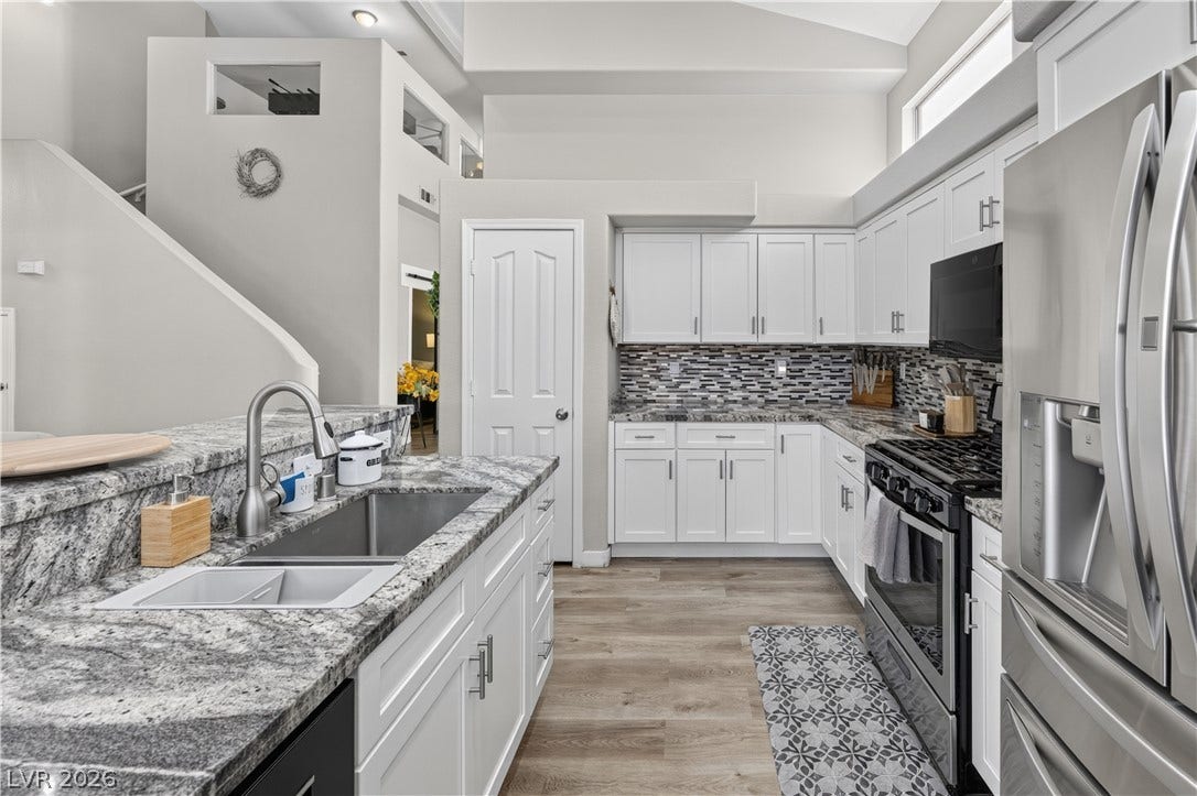 530 Rancho Del Mar Way, North Las Vegas, NV 89031 Granite countertops and clean white cabinetry define this kitchen with soaring vaulted ceilings.