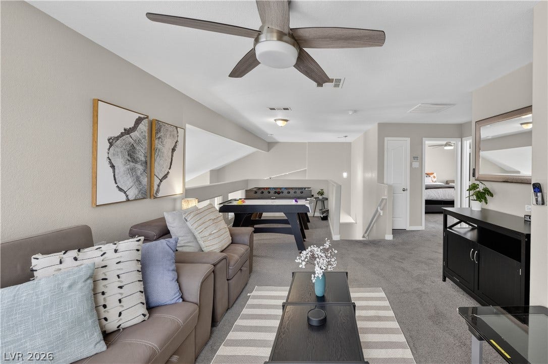 530 Rancho Del Mar Way, North Las Vegas, NV 89031 An open upstairs loft features neutral carpeting, recessed wall details, and vaulted stairwell access.