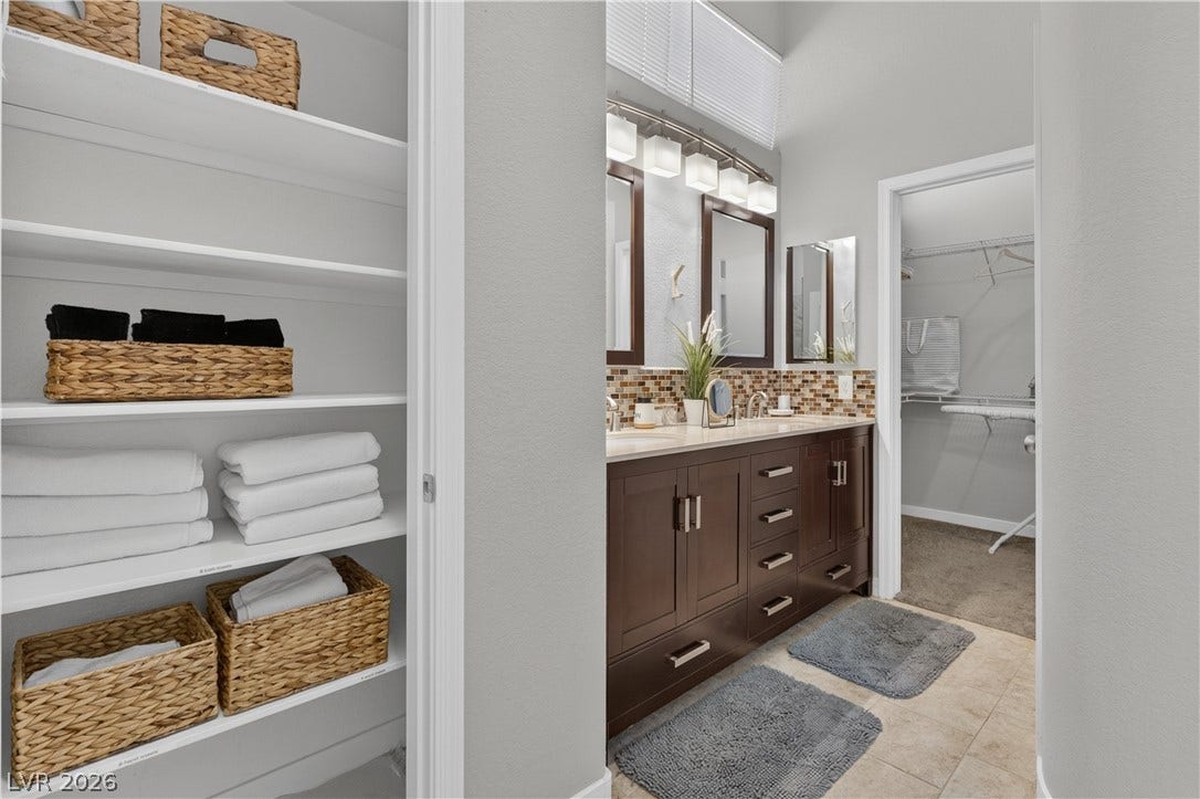 530 Rancho Del Mar Way, North Las Vegas, NV 89031 A spacious double vanity and a built-in linen closet enhance this functional bathroom suite.