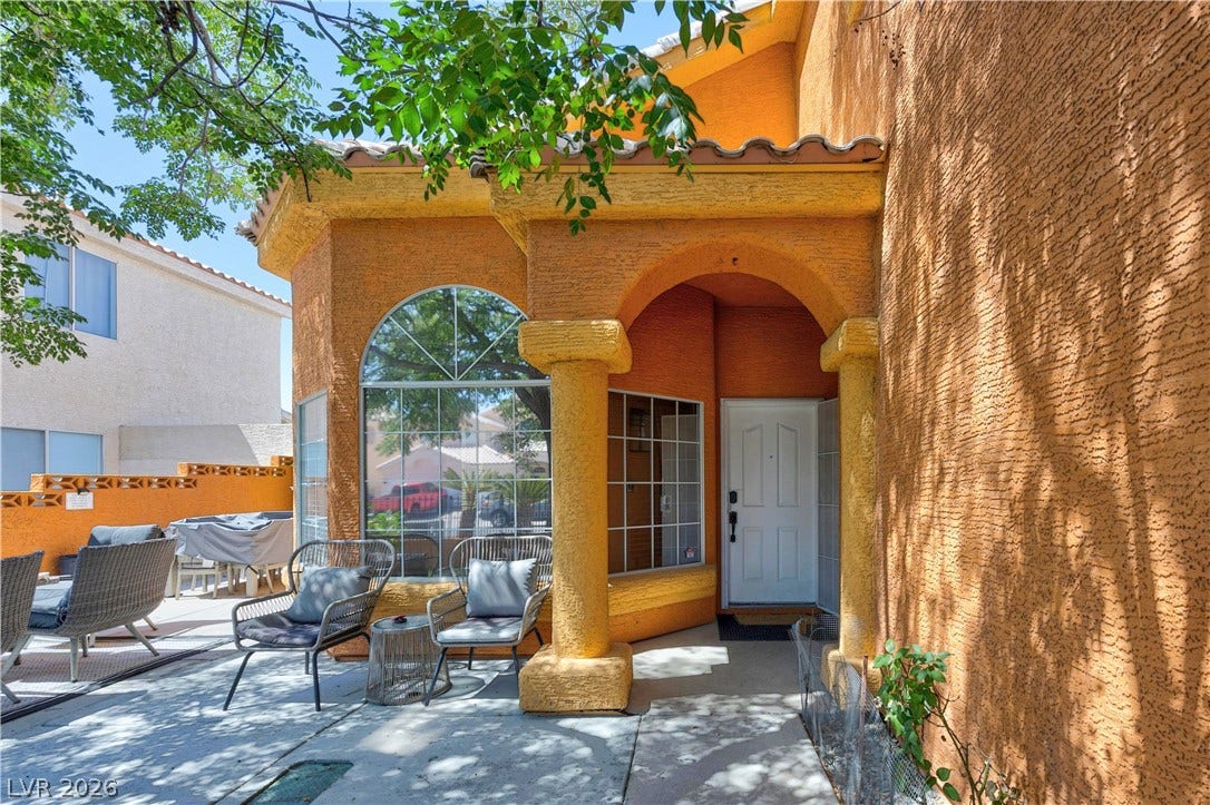 530 Rancho Del Mar Way, North Las Vegas, NV 89031 Spanish tile accents and arched stucco pillars frame a welcoming, sun-washed entryway.