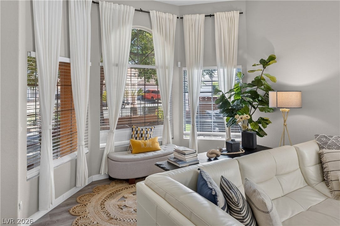 530 Rancho Del Mar Way, North Las Vegas, NV 89031 Towering windows flood this airy living space with natural light.
