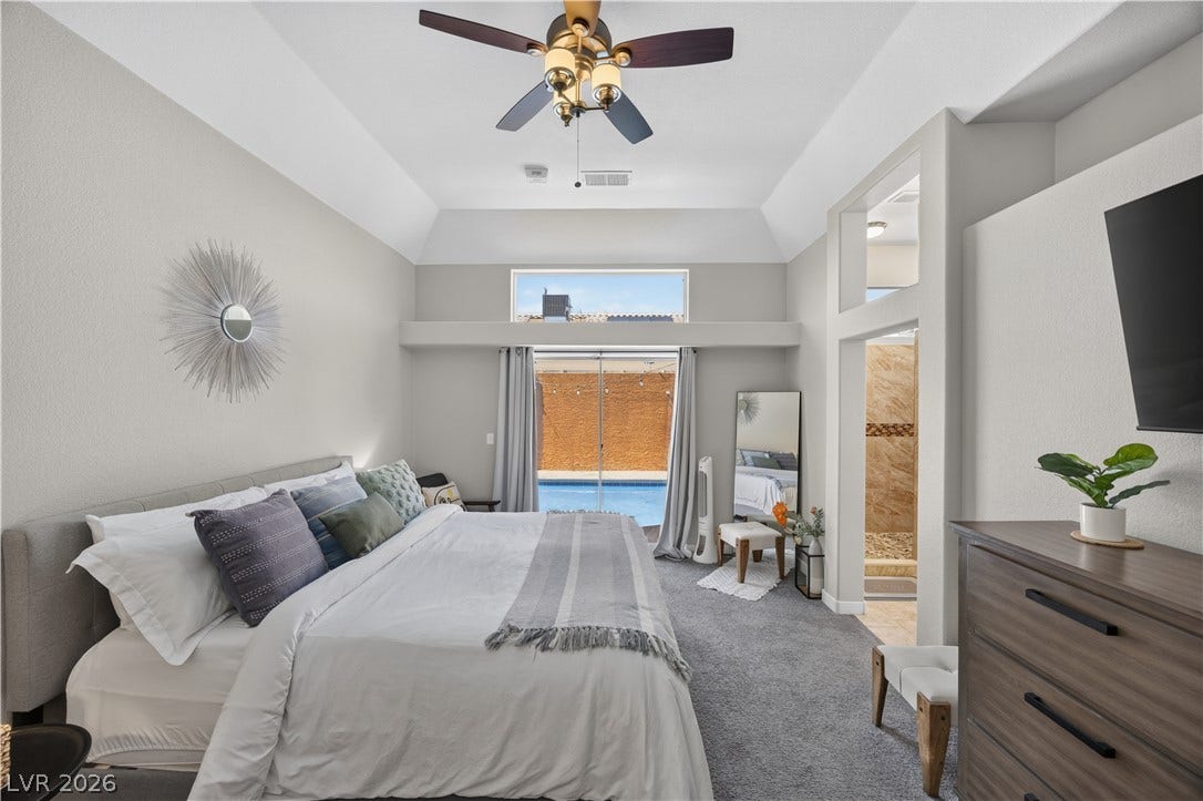530 Rancho Del Mar Way, North Las Vegas, NV 89031 A high tray ceiling and direct pool views highlight this serene sleeping space.