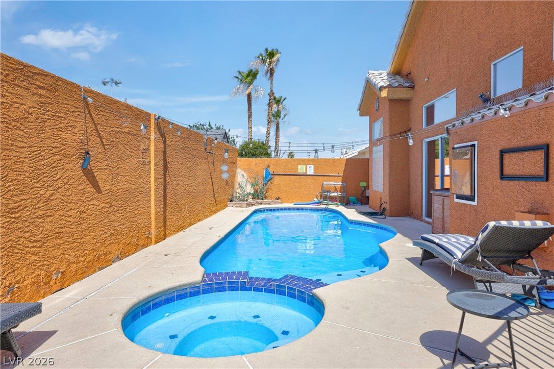 530 Rancho Del Mar Way, North Las Vegas, NV 89031 An inviting in-ground swimming pool and integrated spa sit surrounded by warm stucco walls.