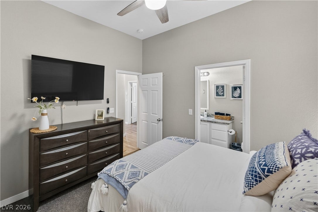 530 Rancho Del Mar Way, North Las Vegas, NV 89031 Plush carpeting and towering ceilings enhance this relaxing bedroom suite with bathroom access.