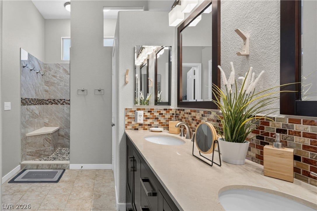 530 Rancho Del Mar Way, North Las Vegas, NV 89031 Clean lines and a tiled walk-in shower define this modern, functional washroom.