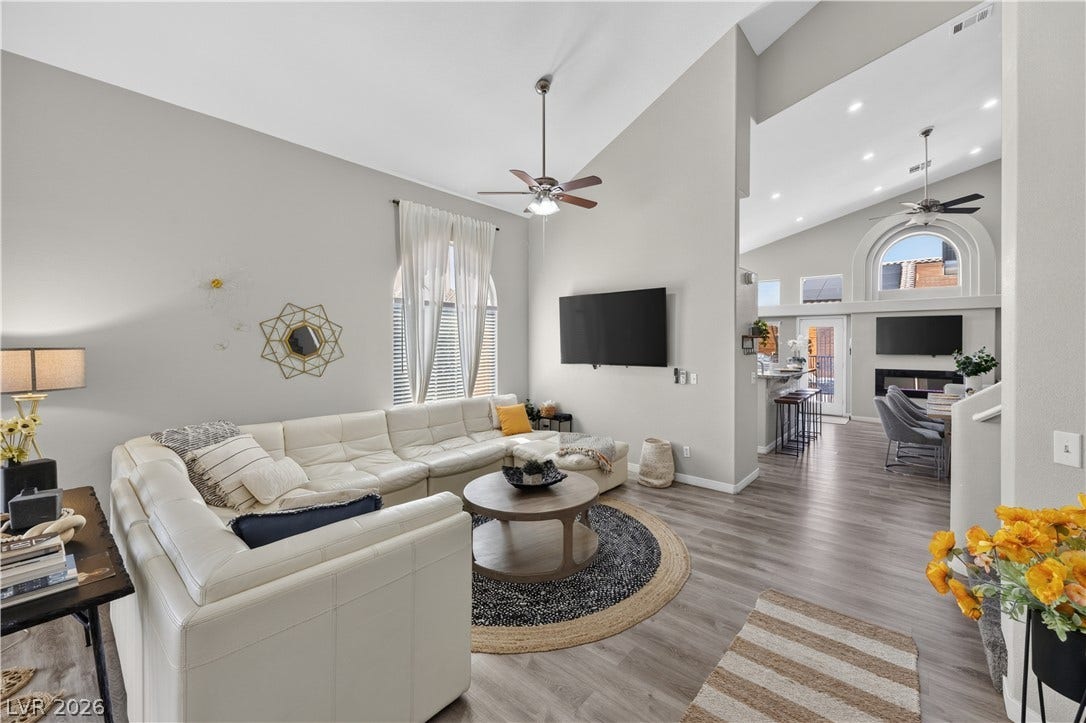 530 Rancho Del Mar Way, North Las Vegas, NV 89031 High vaulted ceilings and wood-style flooring elevate this modern open-concept living space.