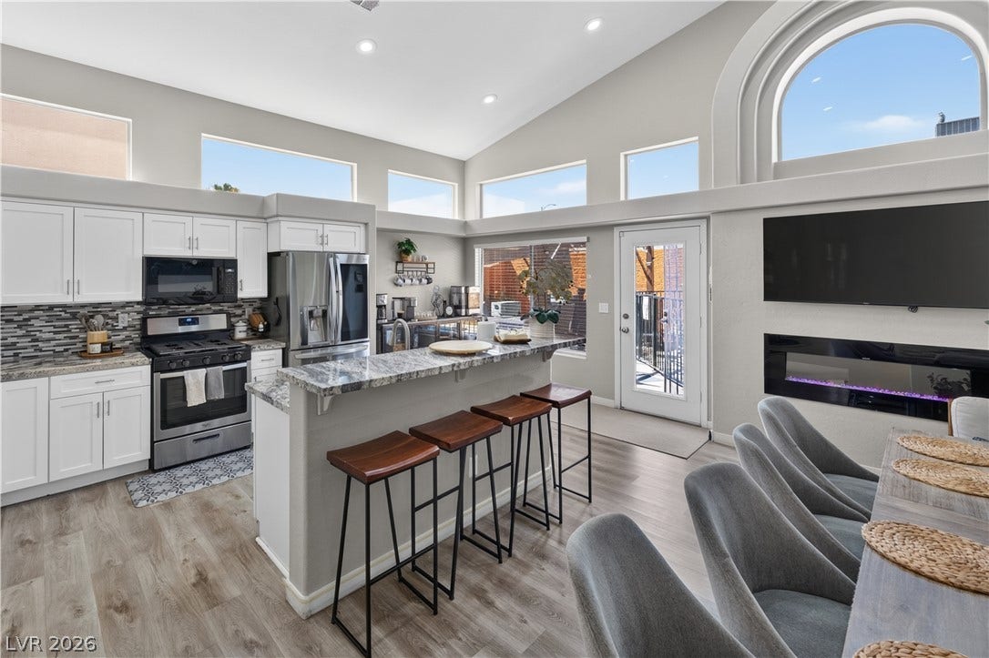 530 Rancho Del Mar Way, North Las Vegas, NV 89031 High ceilings and natural light elevate this open kitchen and dining area.