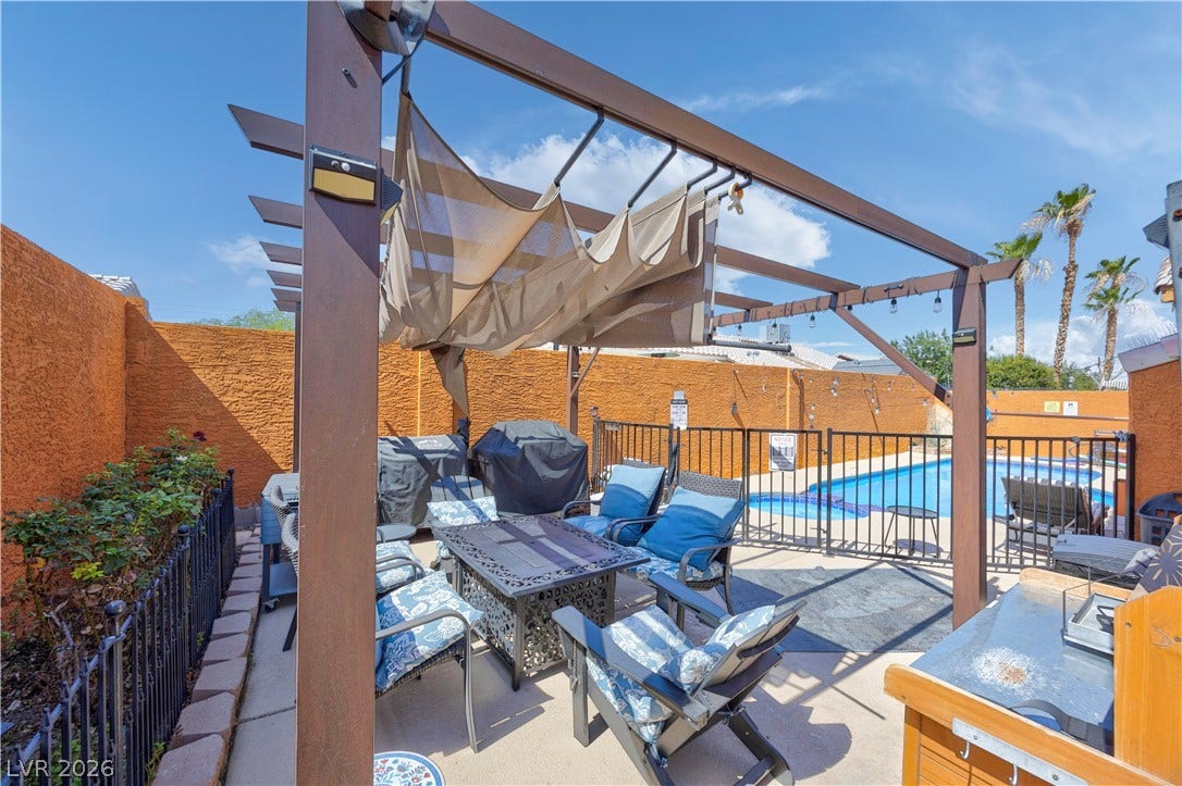 530 Rancho Del Mar Way, North Las Vegas, NV 89031 An inviting outdoor terrace featuring a wooden pergola overlooks the private swimming pool.