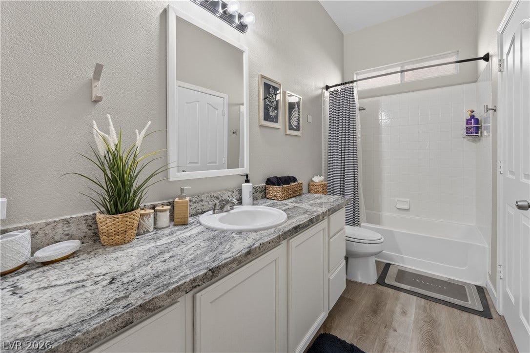 530 Rancho Del Mar Way, North Las Vegas, NV 89031 A spacious vanity with stone countertops highlights this functional bathroom.