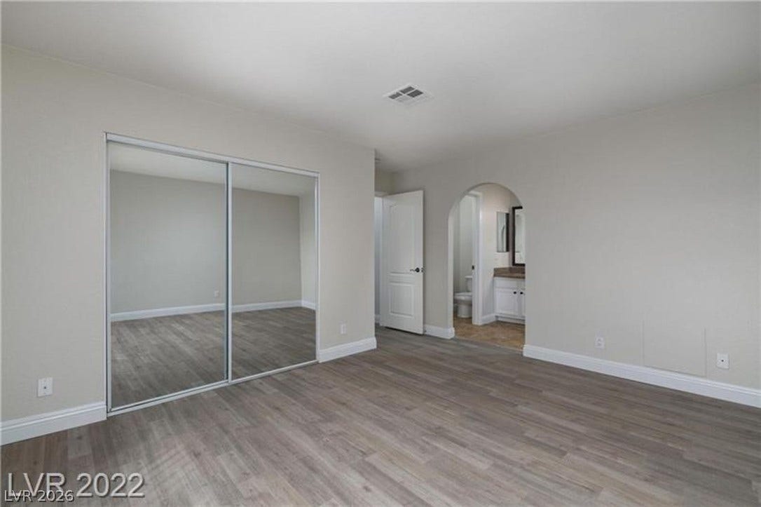 1814 N Decatur Boulevard, #202, Las Vegas, NV 89108 An arched doorway leads to the adjacent bathroom from this spacious bedroom.
