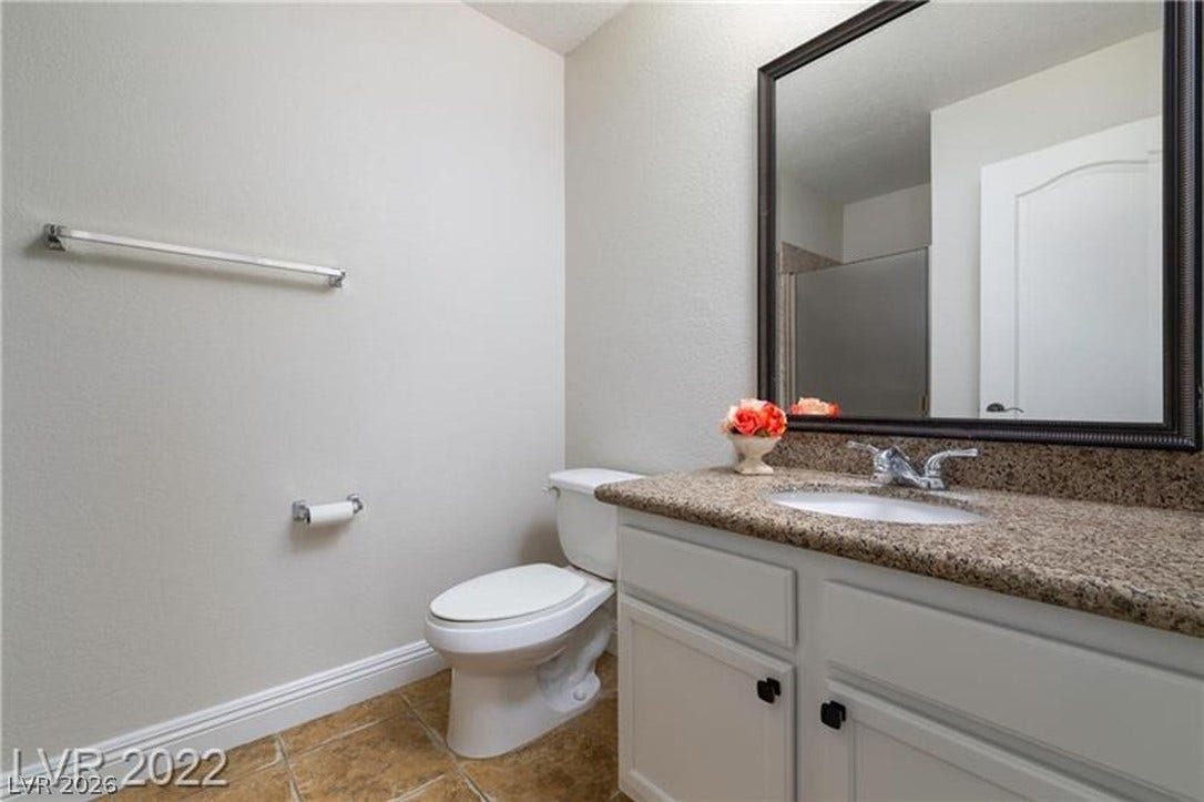 1814 N Decatur Boulevard, #202, Las Vegas, NV 89108 A classic vanity with stone countertops highlights this functional bathroom space.