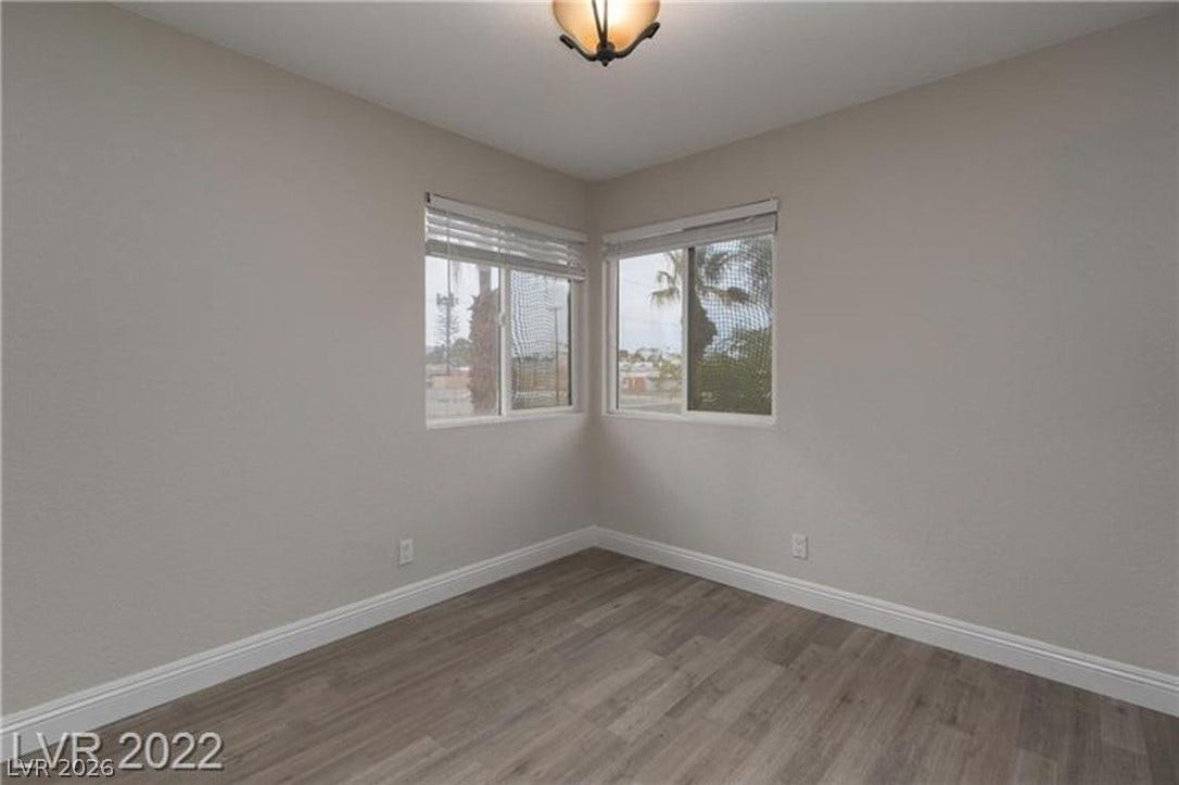 1814 N Decatur Boulevard, #202, Las Vegas, NV 89108 Dual corner windows bring natural light into a versatile room finished with durable plank flooring.
