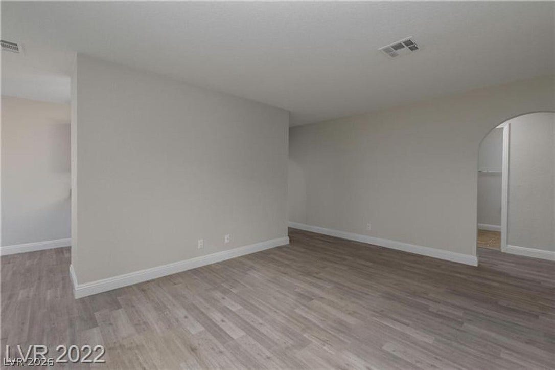 1814 N Decatur Boulevard, #202, Las Vegas, NV 89108 Smooth wood-look flooring and an arched doorway define this versatile living space.