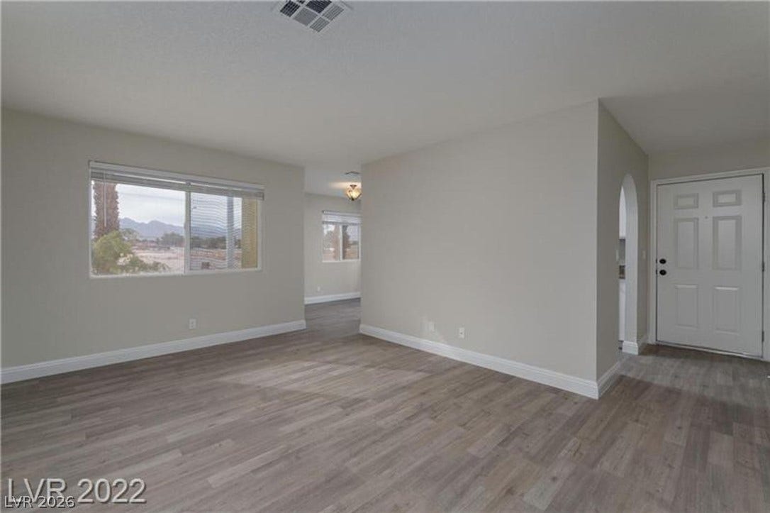 1814 N Decatur Boulevard, #202, Las Vegas, NV 89108 An inviting entryway transitions smoothly into a light-filled living area with modern wood-look flooring.