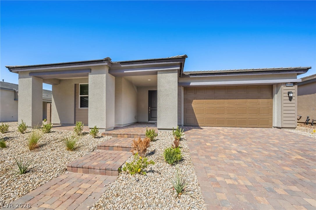 1480 Bianca Falls Drive, Henderson, NV 89011 Modern desert architectural lines and a paver driveway define this pristine single-story facade.
