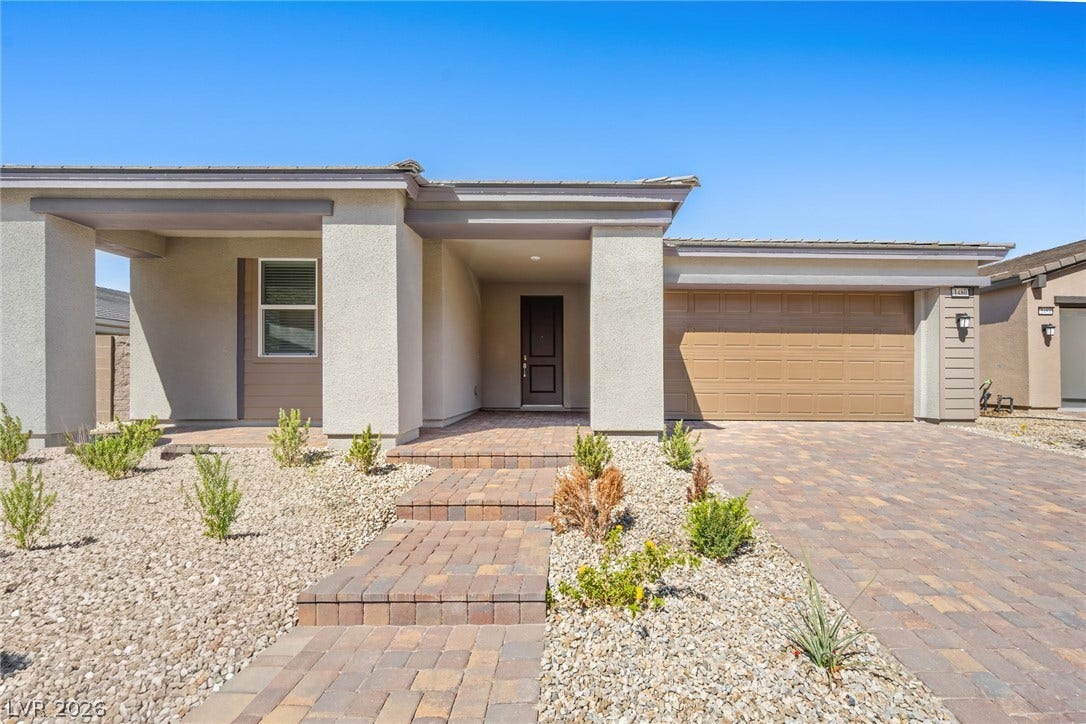 1480 Bianca Falls Drive, Henderson, NV 89011 Clean lines and low-maintenance desert landscaping define the welcoming facade of this modern residence.