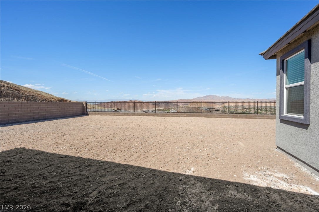 1480 Bianca Falls Drive, Henderson, NV 89011 Expansive desert vistas stretch beyond the secure perimeter of this open backyard space.