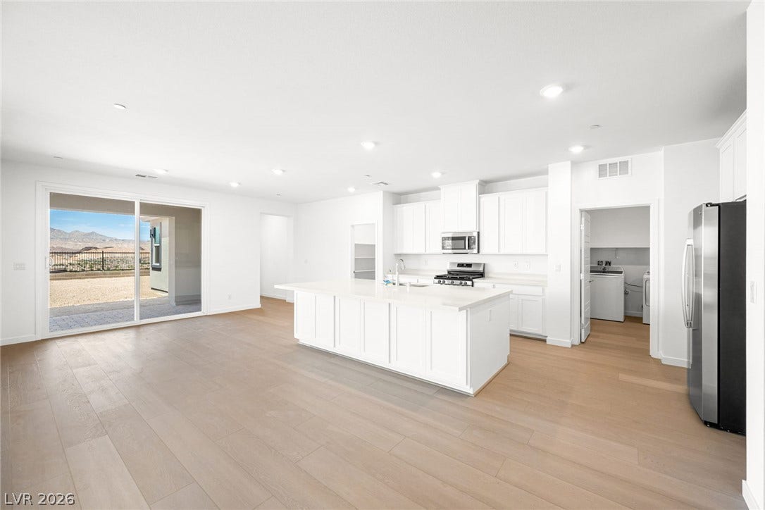 1480 Bianca Falls Drive, Henderson, NV 89011 Sliding glass doors open from the airy kitchen to a private patio space.