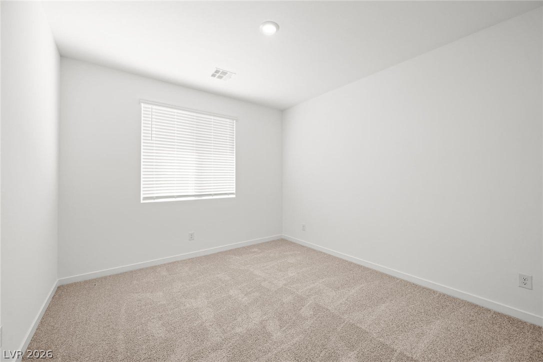 1480 Bianca Falls Drive, Henderson, NV 89011 A window bathes this carpeted bedroom in soft natural light.